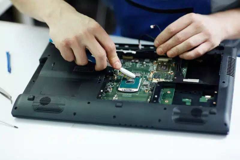 technician fixing a laptop