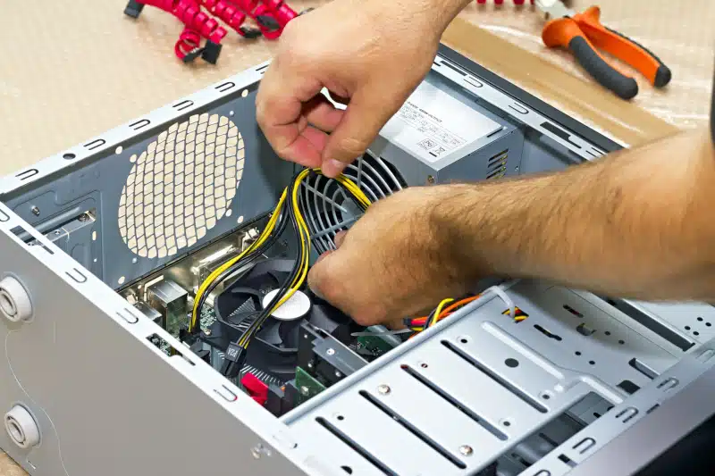 computer technician working inside pc