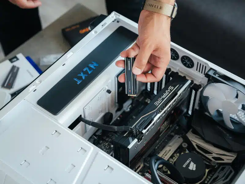 Technician upgrading a computer with a solid-state drive to improve speed and performance.